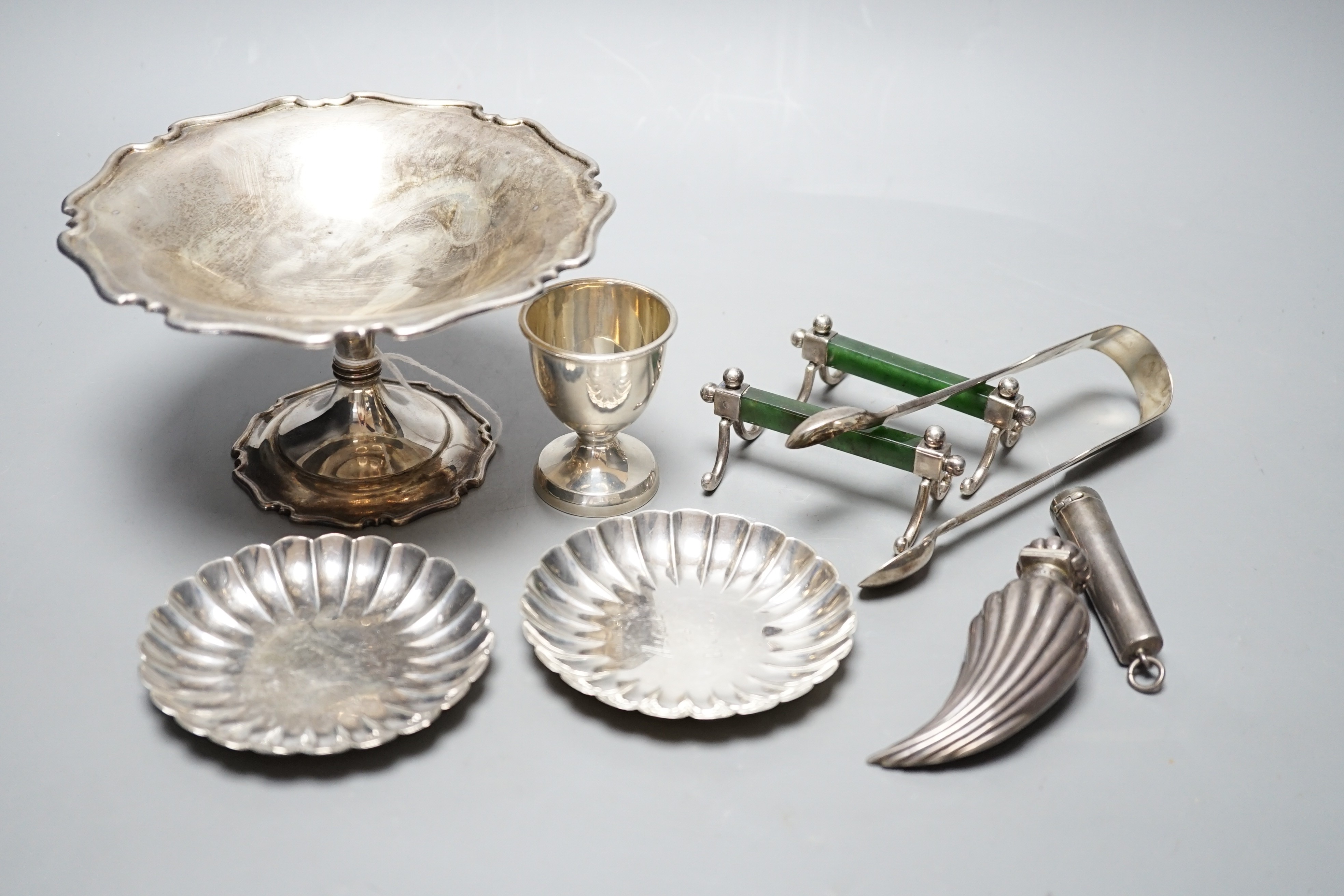 A George V silver tazze, diameter 14.7cm, two small sterling nut dishes, a late Victorian fluted silver scent bottle, of curved form, Horton & Allday, Birmingham, 1889, a pair of silver and nephrite mounted knife rests,